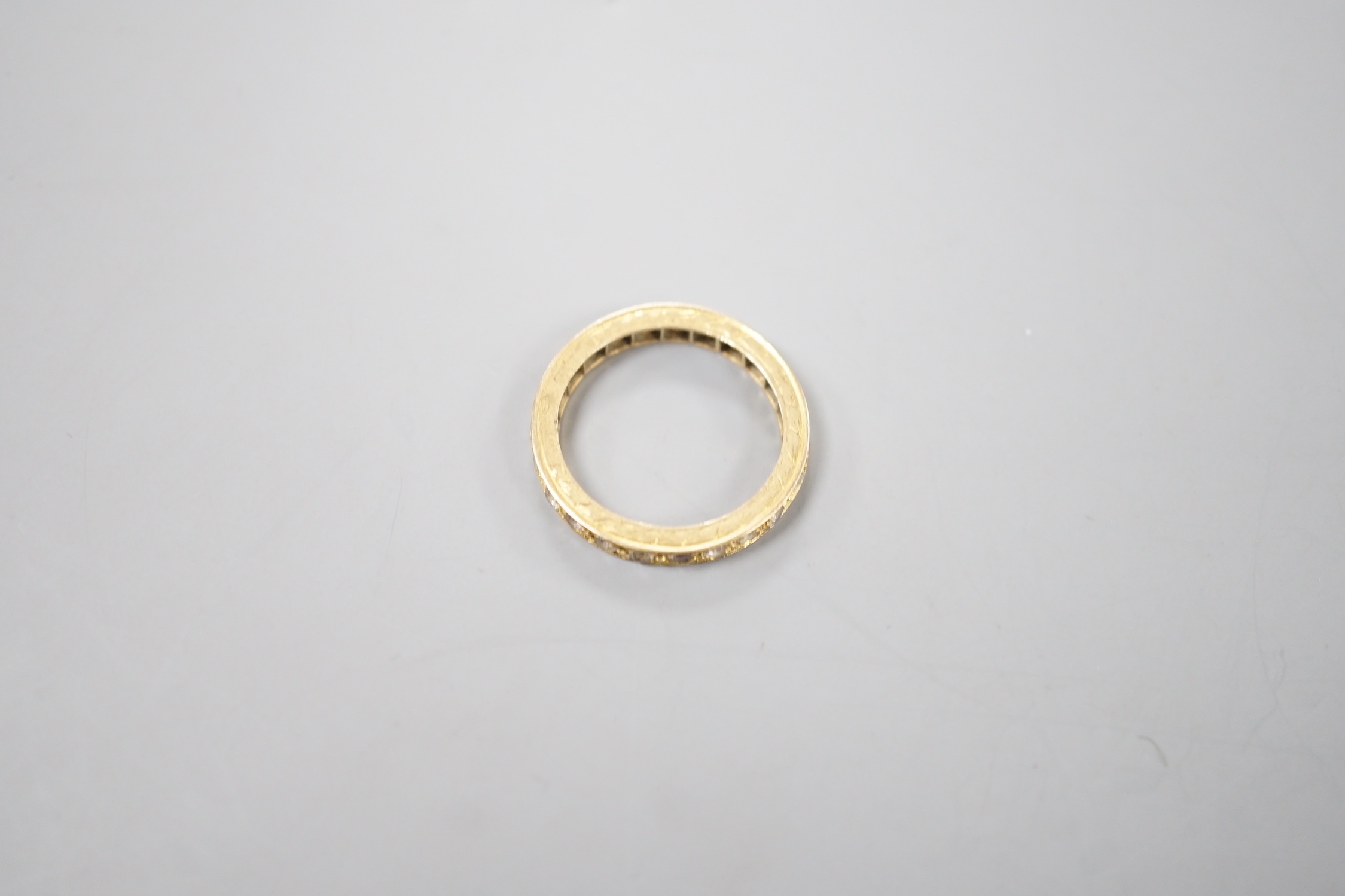 An 18ct and diamond chip set full eternity ring, size L, gross weight 3.4 grams.